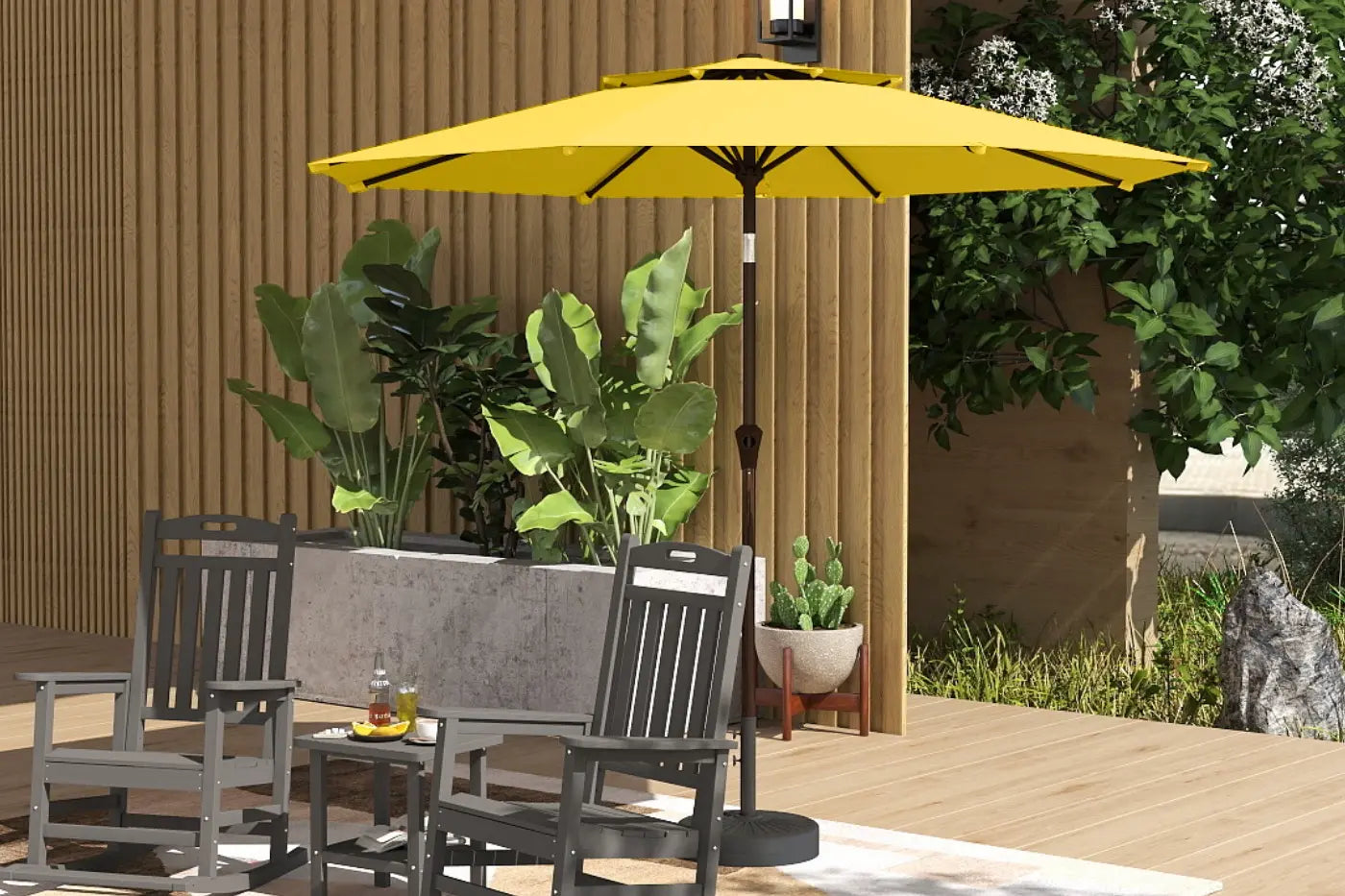 Yellow patio umbrella over outdoor furniture with plants and a wooden wall in the background
