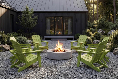 Green Adirondack chairs around a fire pit in front of a dark wooden cabin.