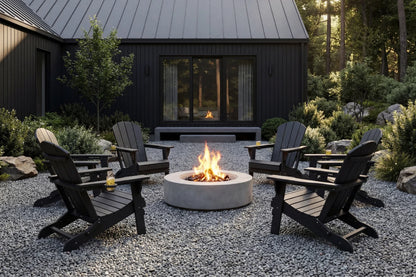 Outdoor patio with Adirondack chairs around a fire pit in front of a black cabin.