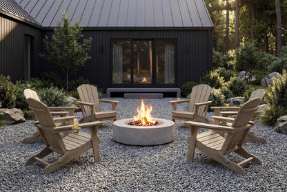 Outdoor setting with HDPE chairs around a fire pit in front of a dark-colored building.