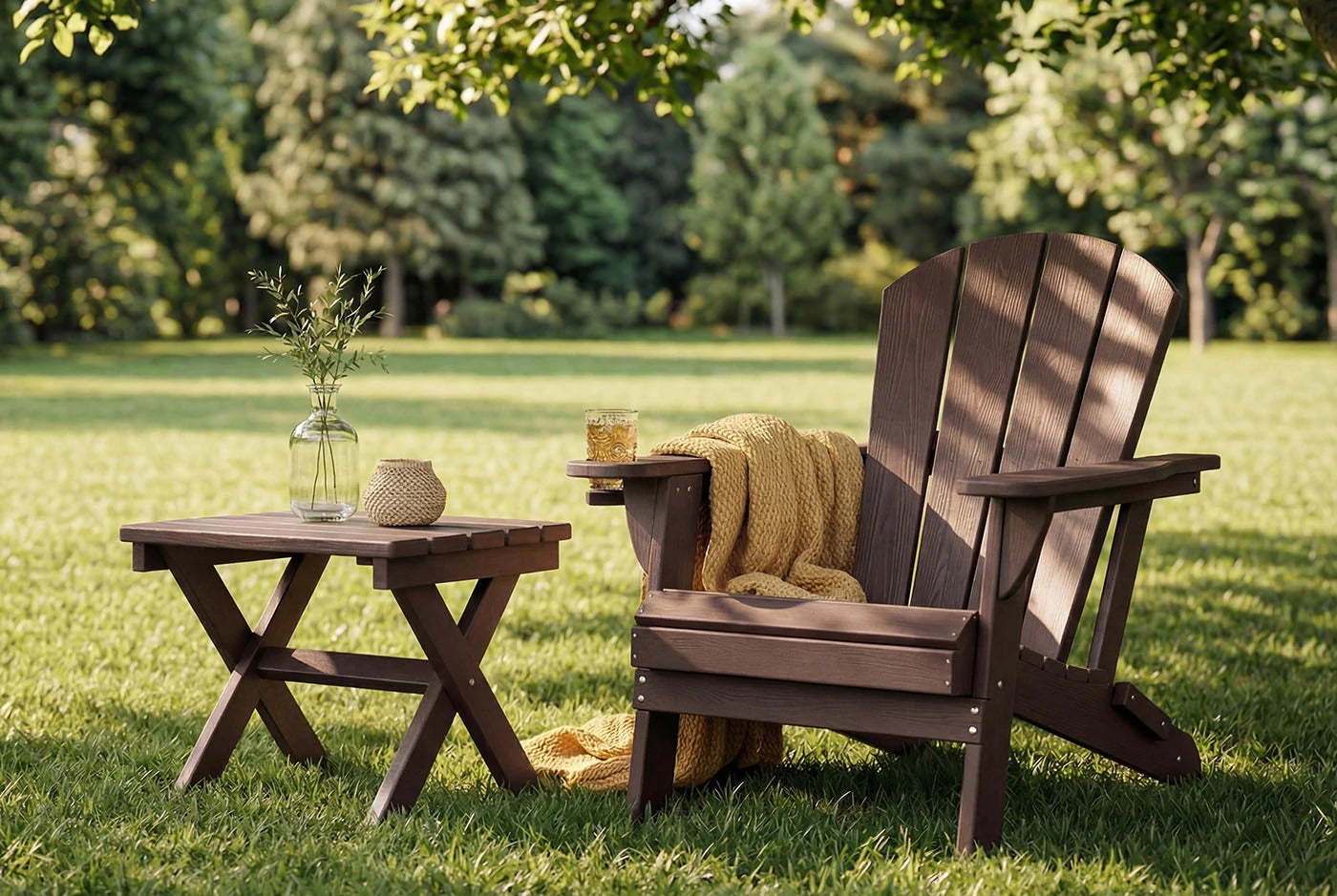 HDPE Adirondack chair with a small table on a grassy lawn with trees in the background