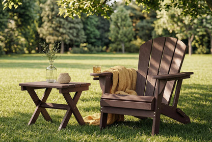 HDPE Adirondack chair with a small table on a grassy lawn with trees in the background