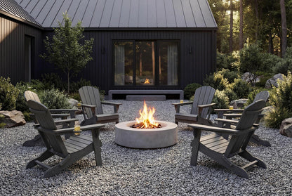 Outdoor patio with fire pit and Adirondack chairs in front of a cabin.