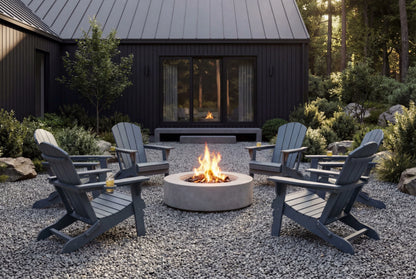 Outdoor setting with Adirondack chairs around a fire pit in front of a cabin.