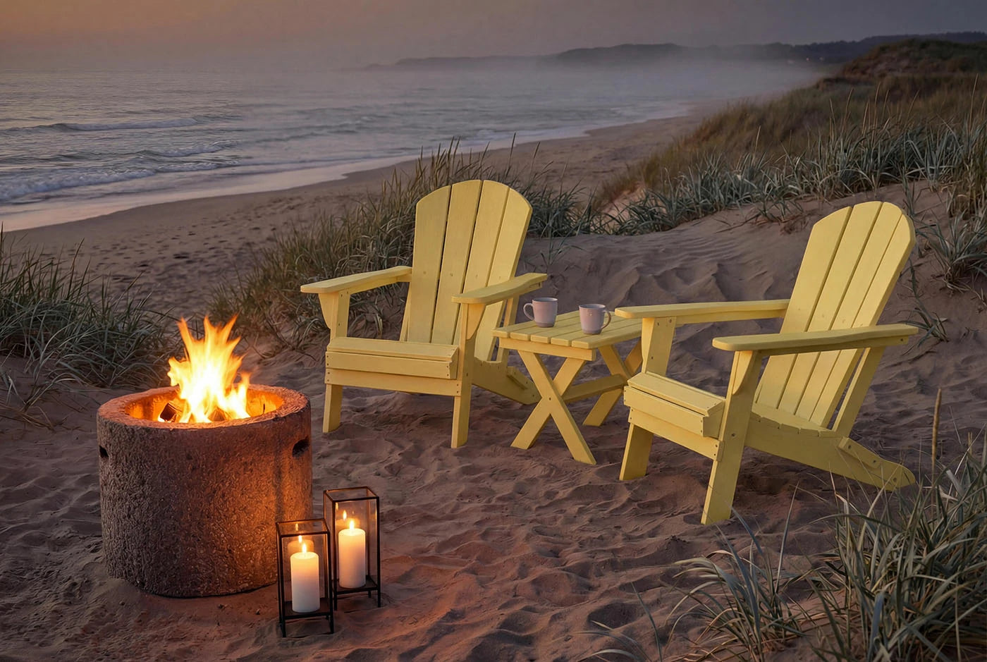 Two Adirondack chairs with a fire pit and candles on a sandy beach at dusk.
