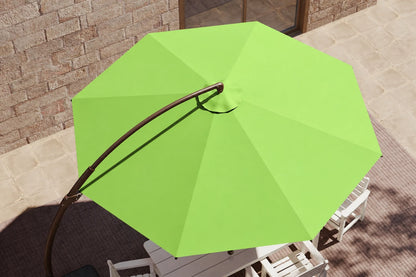 Apple pink patio umbrella with a curved black metal pole, shown from an overhead angle in an outdoor patio setting with white chairs and a stone wall background.