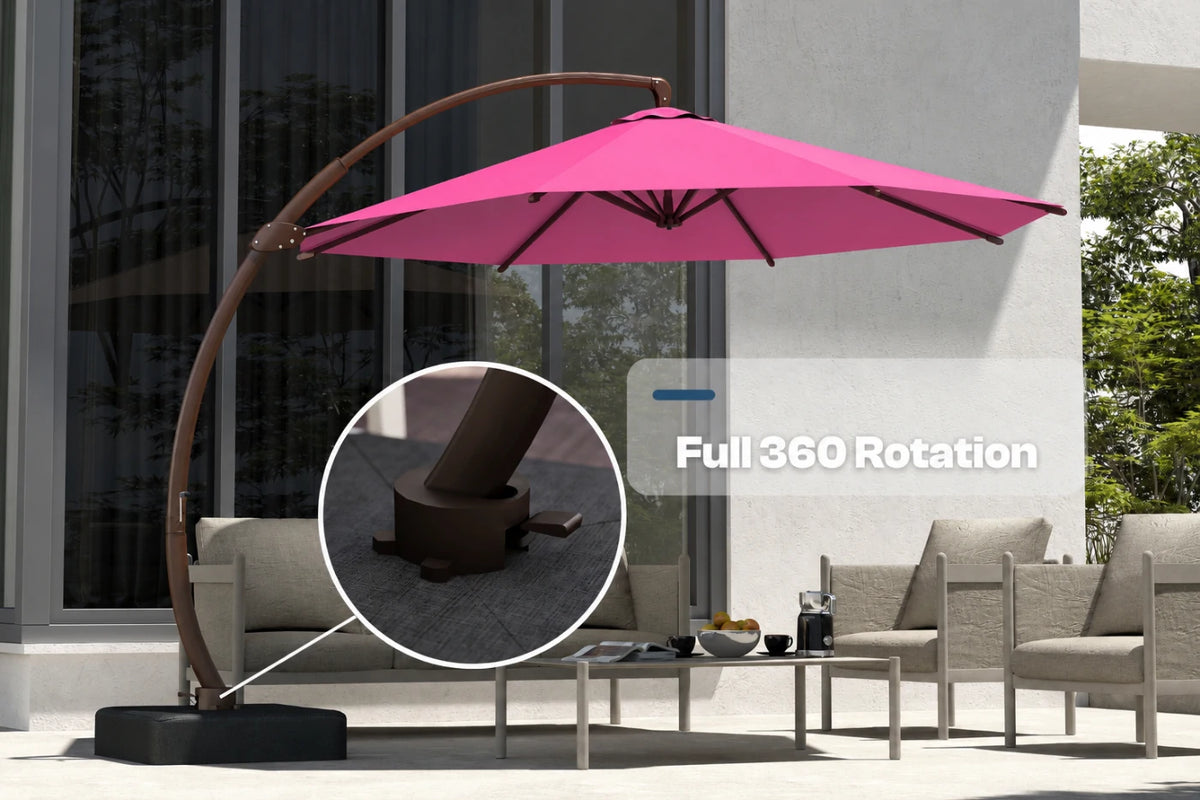 An outdoor patio scene with a large rose pink cantilever umbrella on a curved metal frame, shown beside lounge chairs and a coffee table. A circular inset highlights the base hardware, and text reads 'Full 360 Rotation.