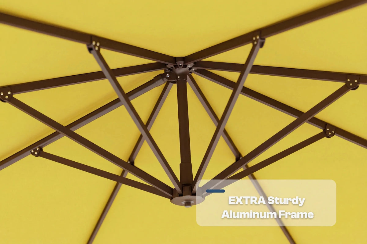 Close-up underside view of a yellow patio umbrella showing the dark aluminum canopy frame structure, with a text overlay that reads 'EXTRA Sturdy Aluminum Frame'.