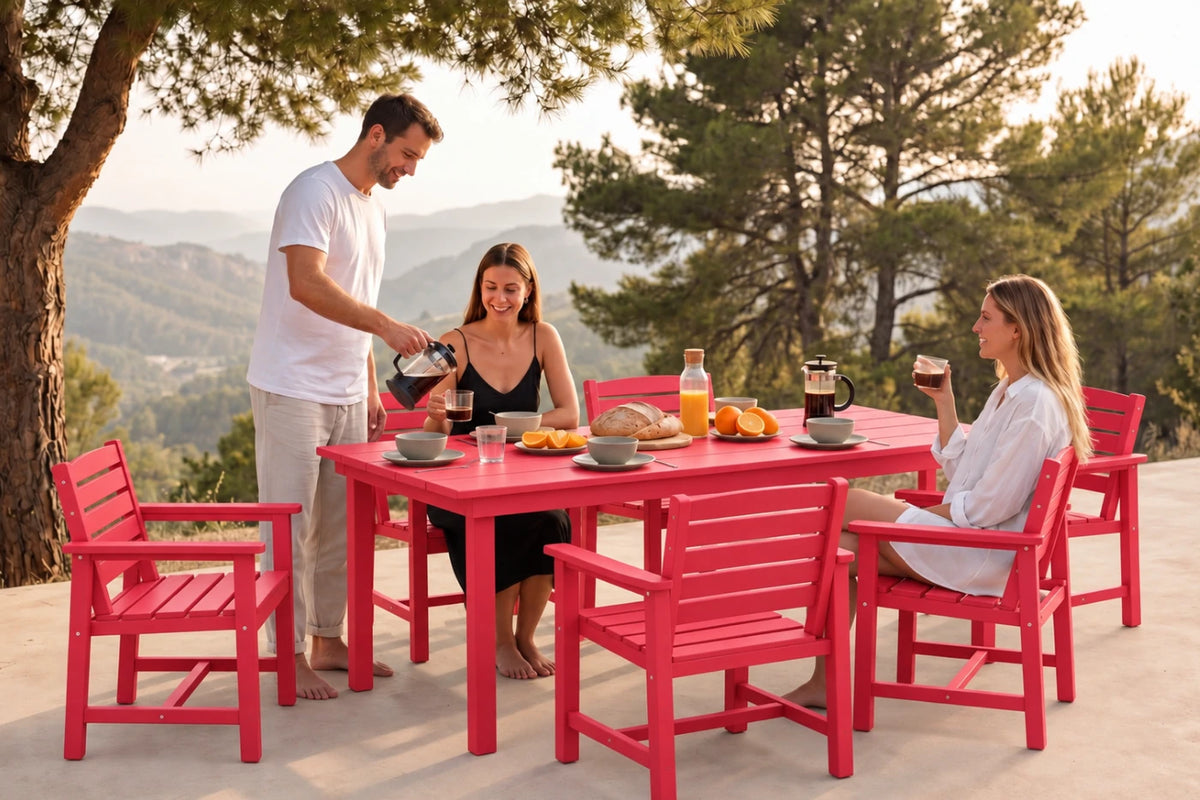 A red outdoor dining set with a rectangular table and 6 matching chairs, shown in use by three people on a patio with a scenic mountain background at sunset.