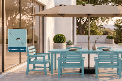 An Aruba blue outdoor dining set with matching chairs and a beige patio umbrella on a sunlit patio beside a glass wall. A callout box on the left highlights the 2-inch umbrella hole.