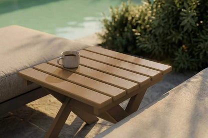HDPE side table with a cup on it by a poolside