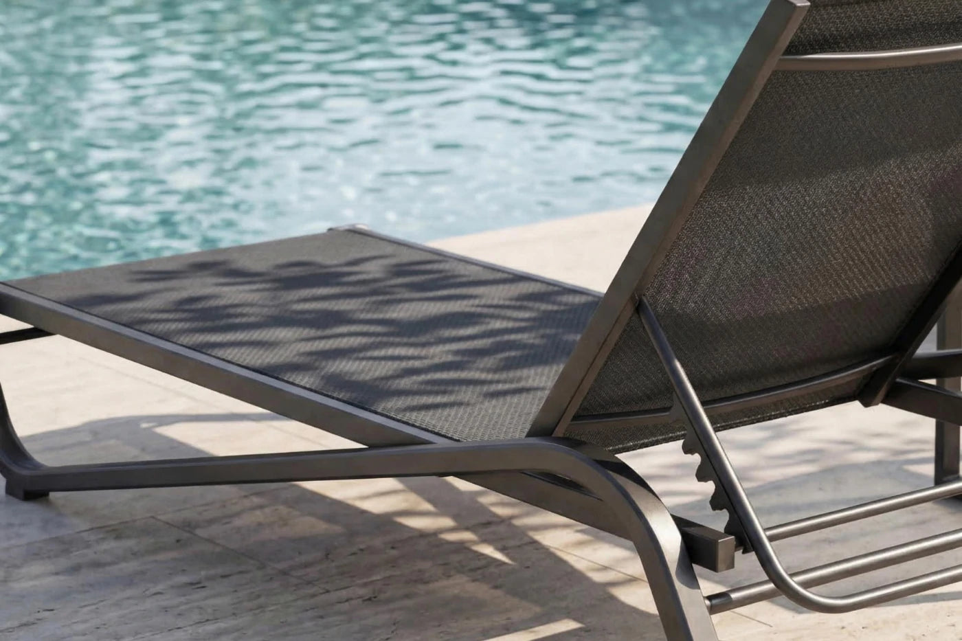 Black lounge chair by a pool