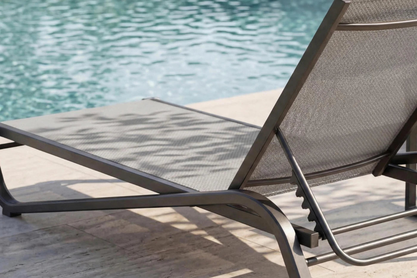 Gray lounge chair by a pool