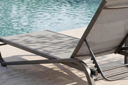 Gray lounge chair by a pool