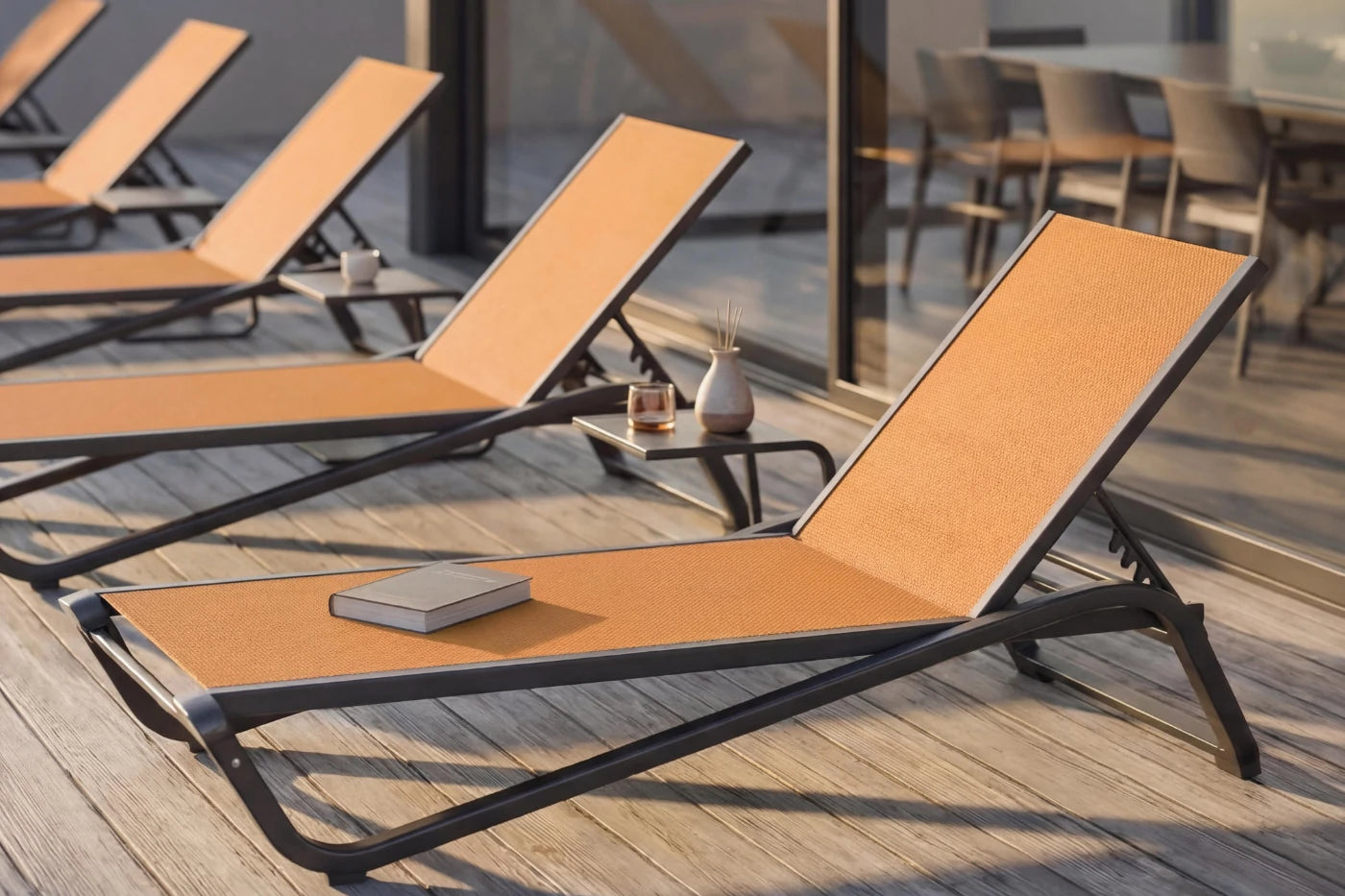 Orange lounge chairs on a wooden deck with a blurred background