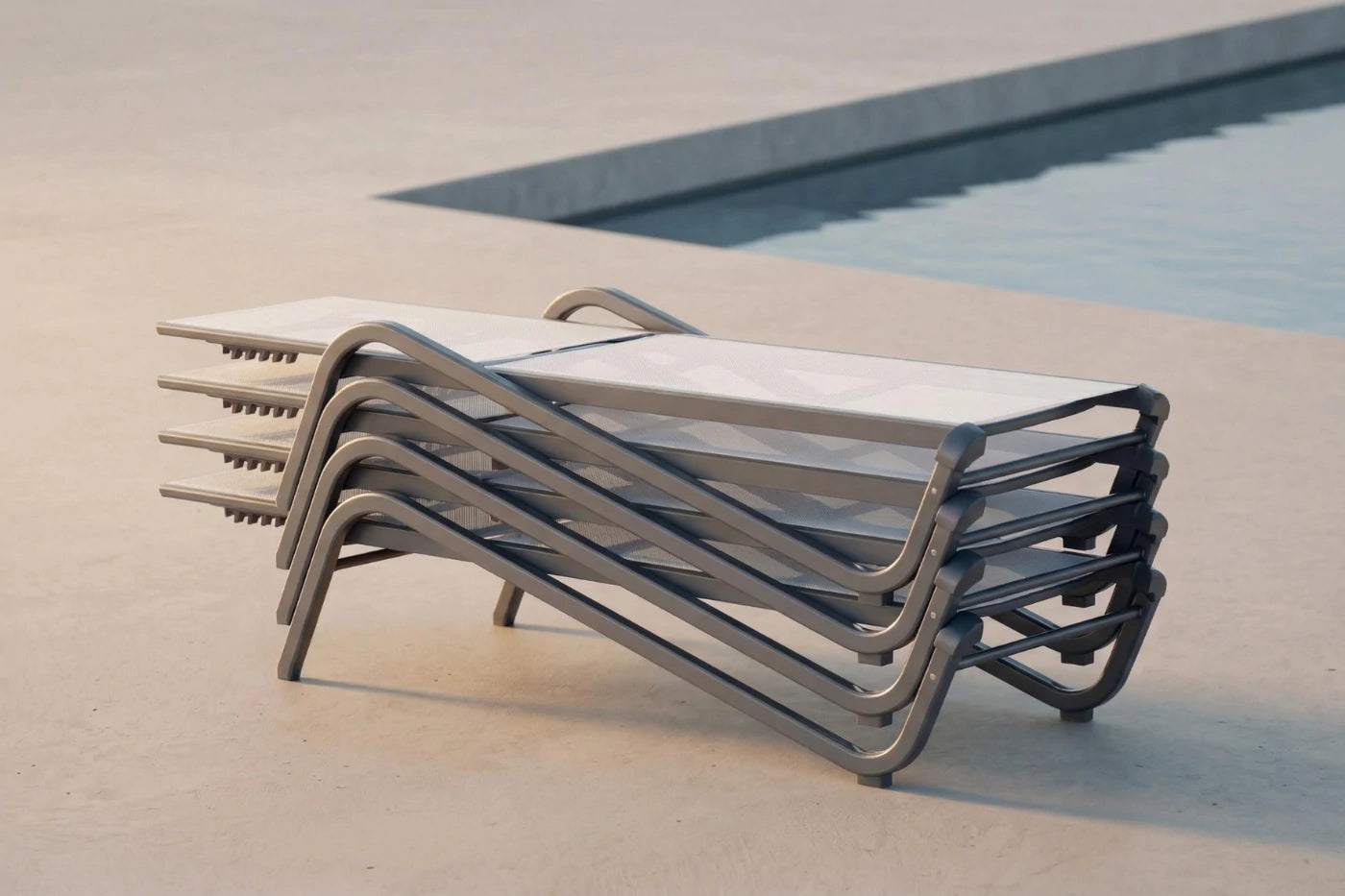 Stack of metal outdoor lounge chairs by a pool