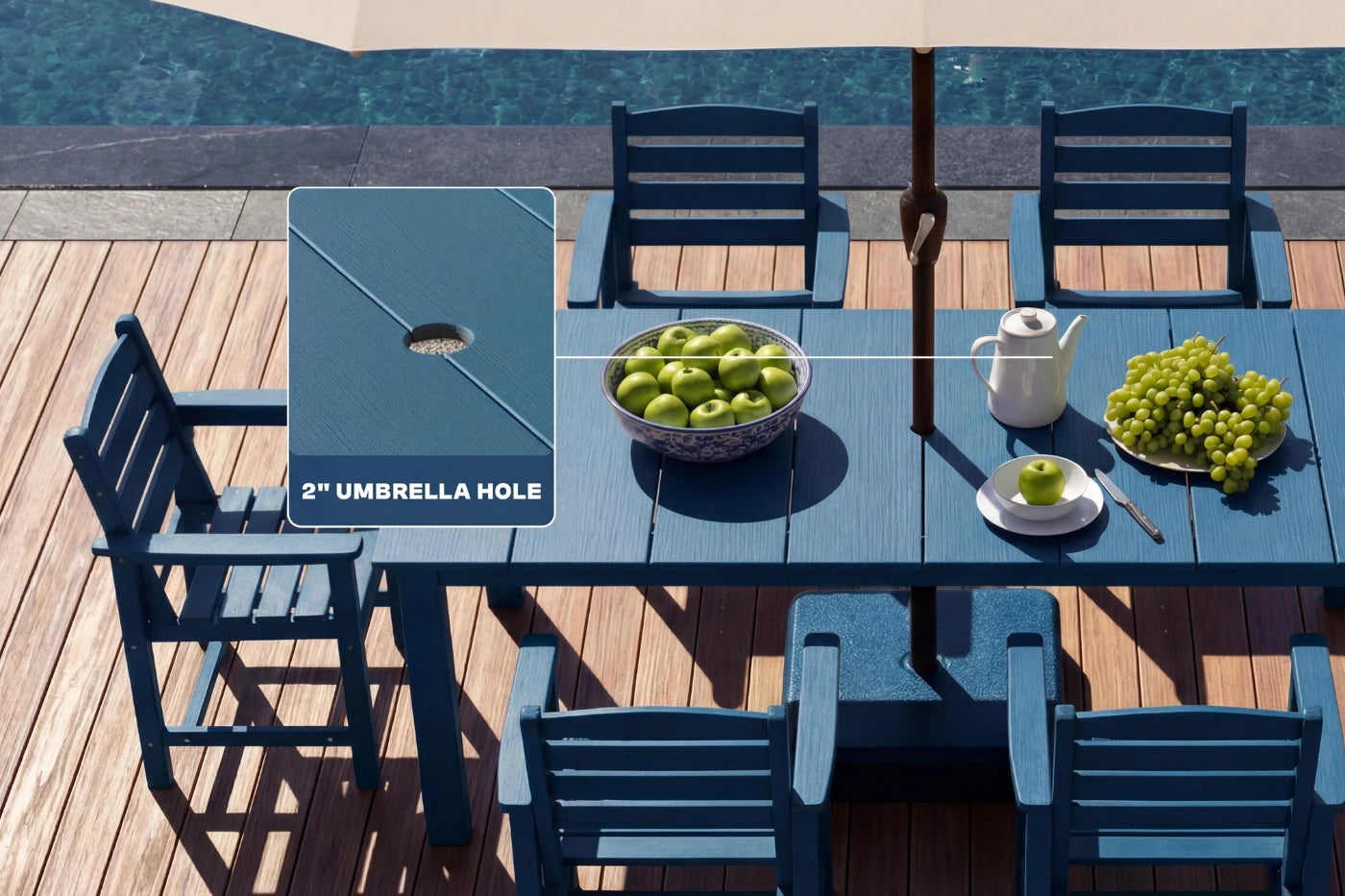 Blue outdoor table with chairs and a bowl of apples near a pool