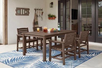 HDPE dining set with chairs on a blue and white patterned rug in a room with large windows.