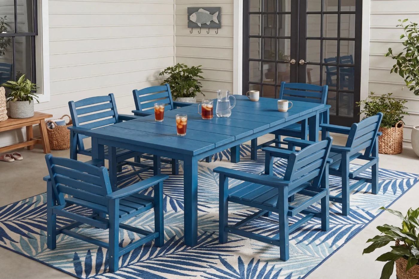 Blue outdoor dining set with table and chairs on a patio