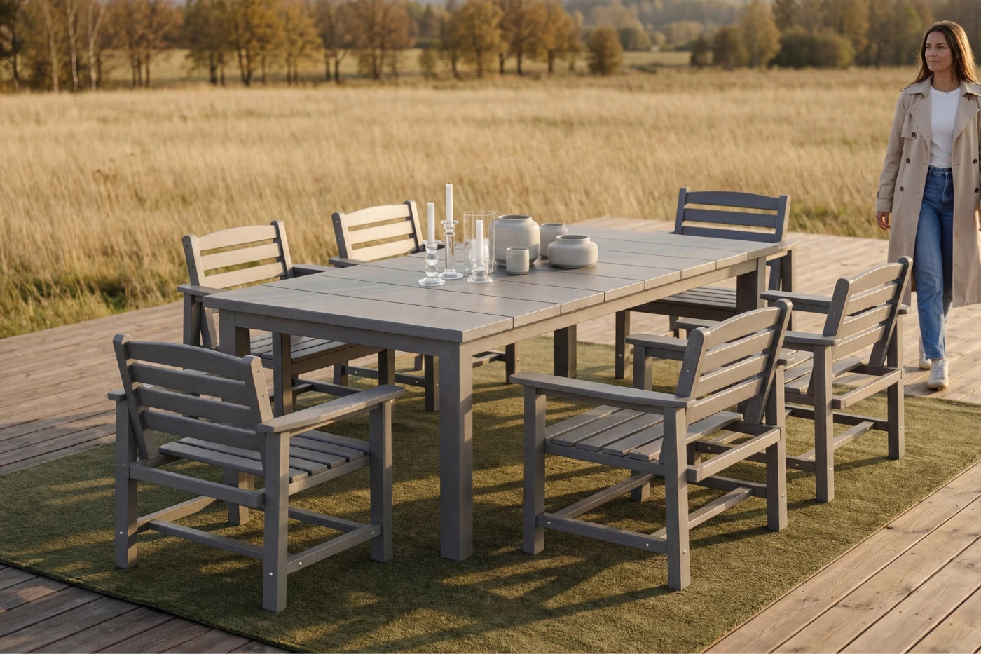 Outdoor dining set with HDPE table and chairs on a deck overlooking a field.