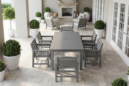 Outdoor patio set with table and chairs on a tiled patio, surrounded by potted plants.