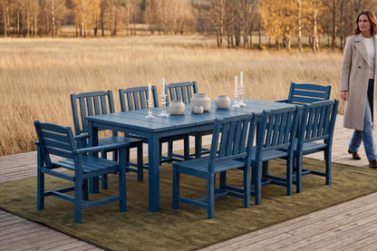 Blue outdoor dining set with chairs on a wooden deck by a field