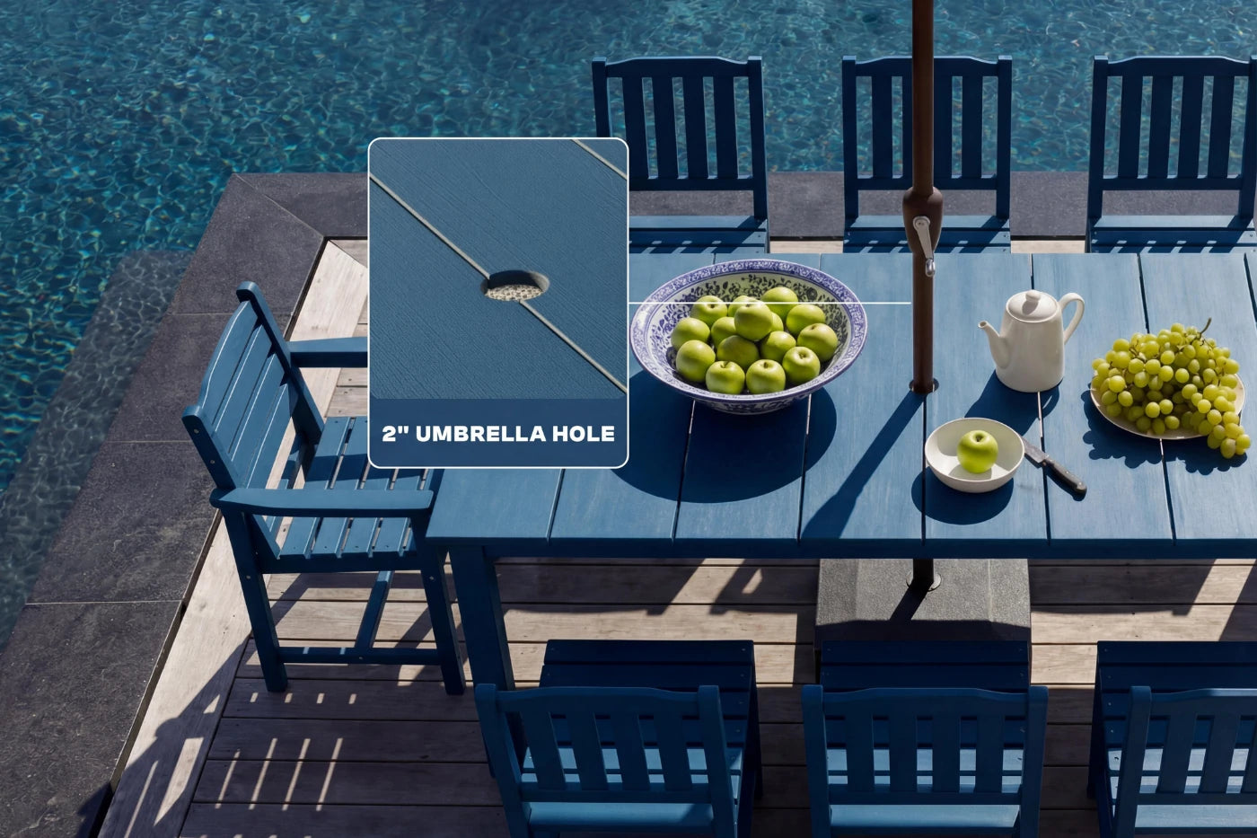 Outdoor dining set with blue chairs and table by a pool, featuring an umbrella hole.