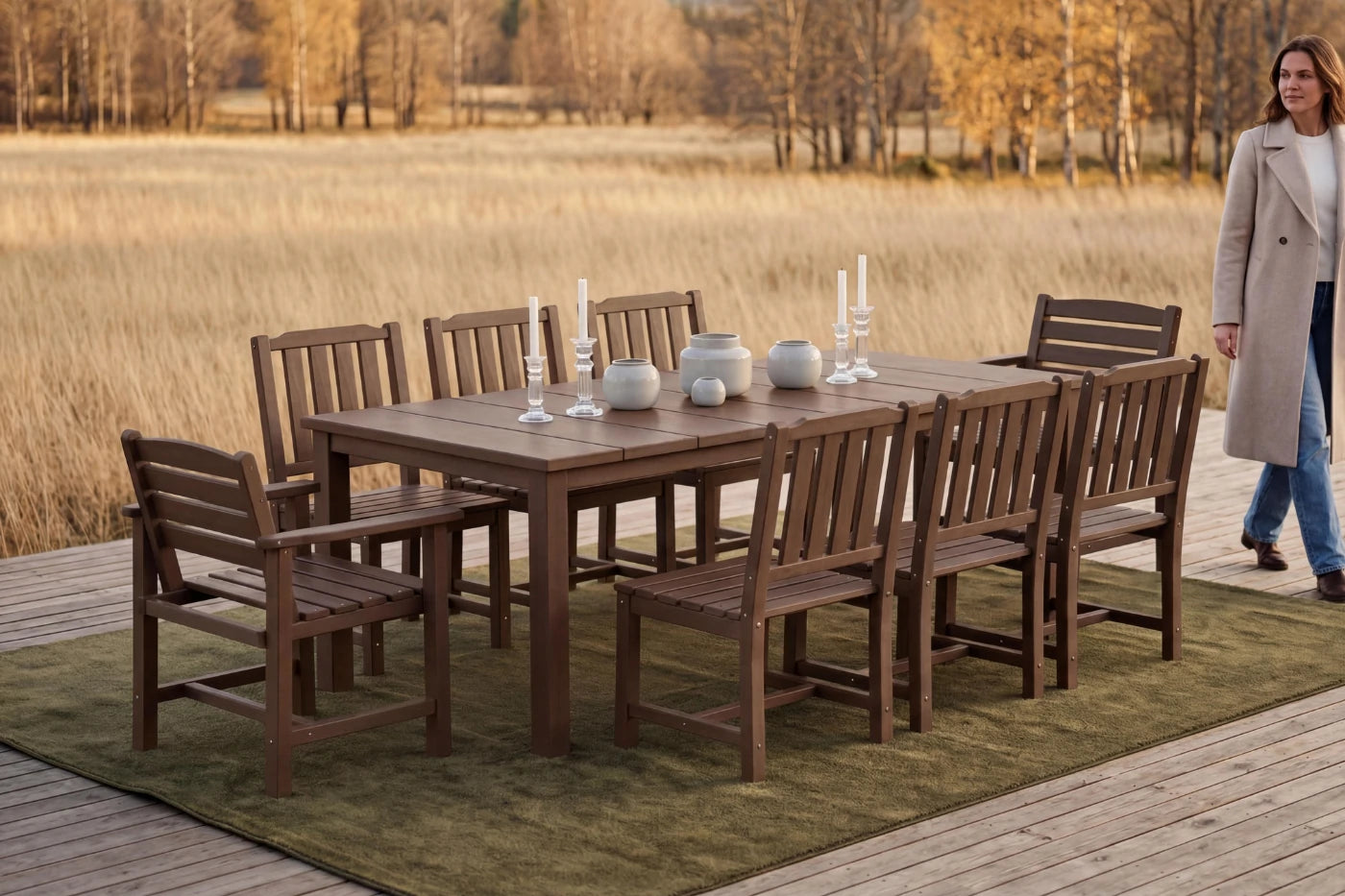 HDPE outdoor dining set with chairs and a table on a deck, with a person walking in the background.