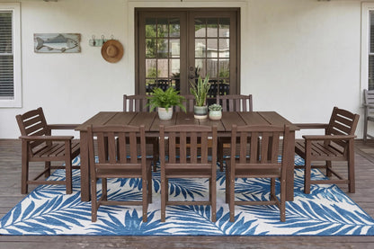 HDPE  outdoor dining set with chairs and table on a deck with a blue and white patterned rug.