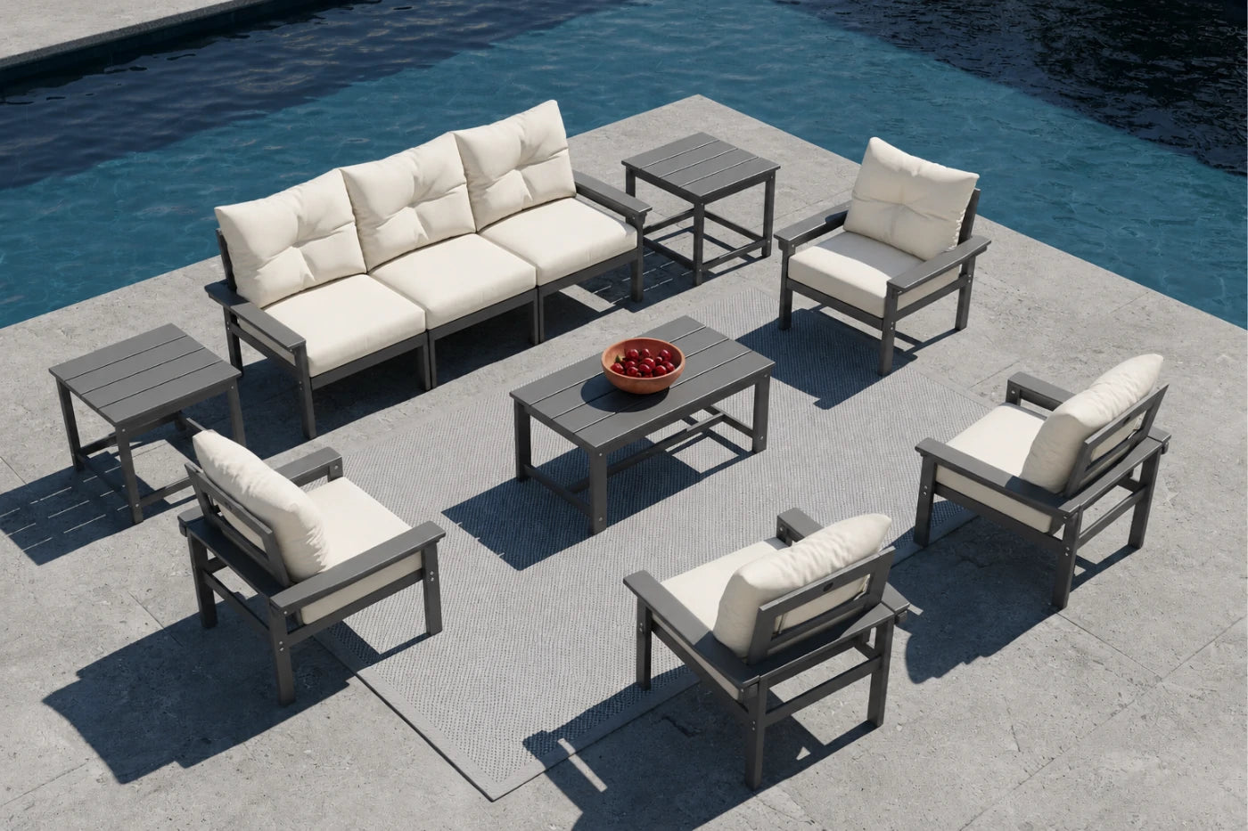 Outdoor patio furniture set with beige cushions by a pool