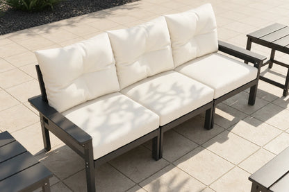 Outdoor patio set with white cushions on a tiled patio