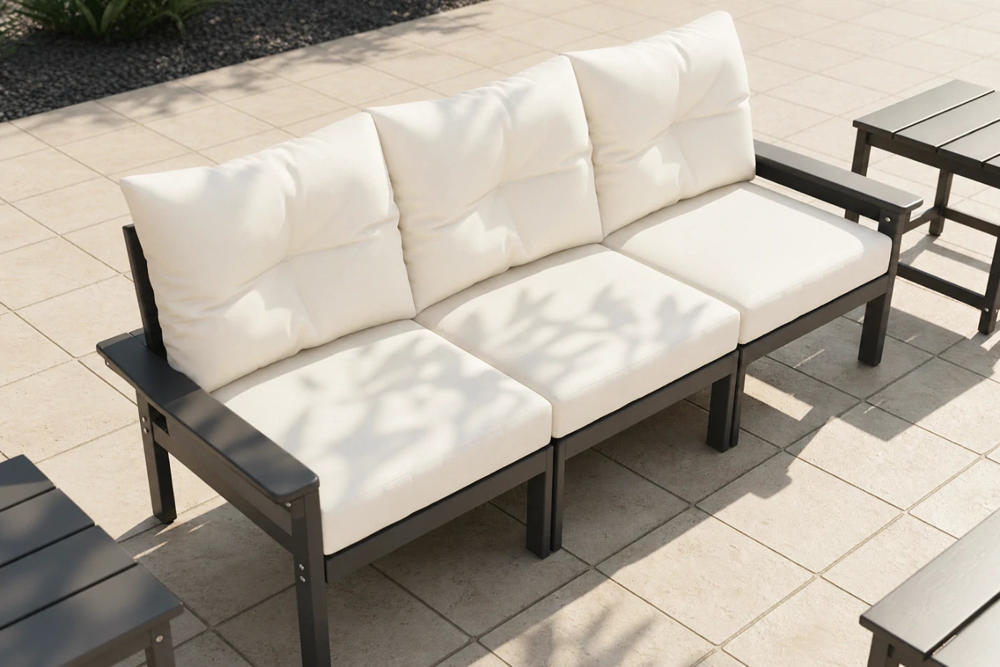 Outdoor patio set with white cushions on a tiled patio