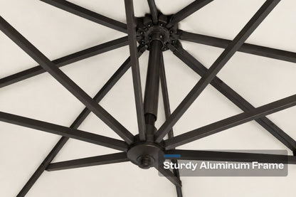 Close-up of a black aluminum patio umbrella frame with radiating ribs against a creamy white canopy background, with a text overlay reading 'Sturdy Aluminum Frame'.