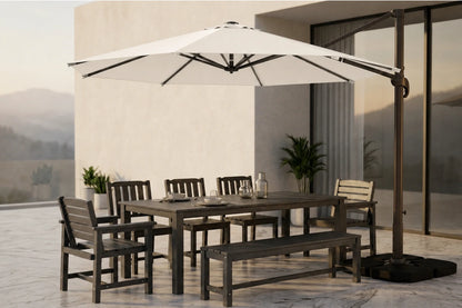Outdoor patio dining set with a rectangular table, matching chairs and bench, and a large white cantilever umbrella on a tiled terrace beside a modern building.