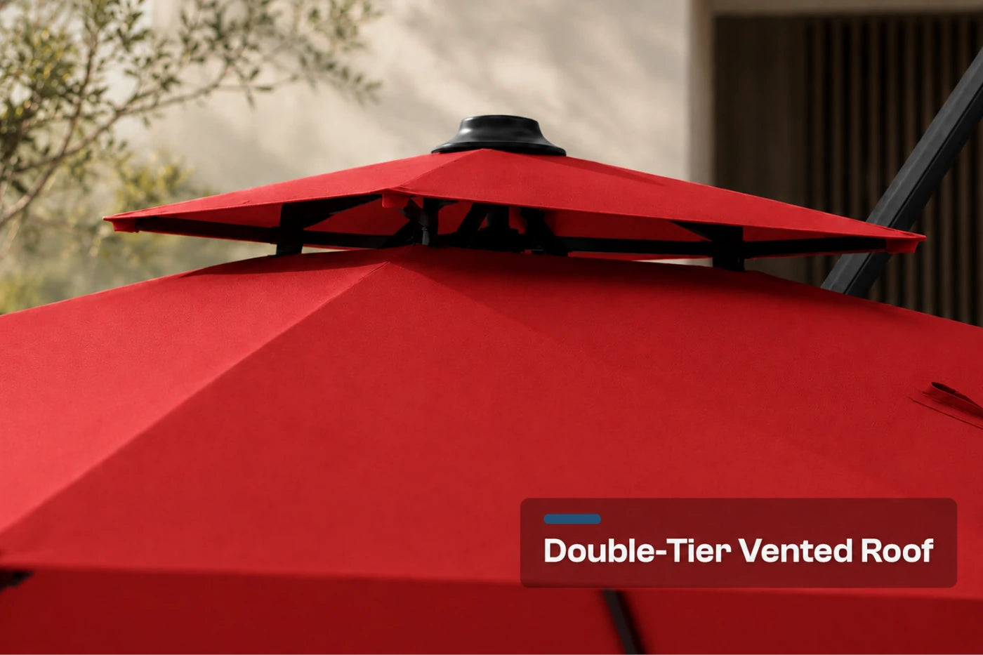 Close-up of a red patio umbrella showing the double-tier vented roof structure, with a text label reading 'Double-Tier Vented Roof' in the lower right corner.