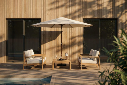 Outdoor patio set with two chairs, a table, and an umbrella on a wooden deck.