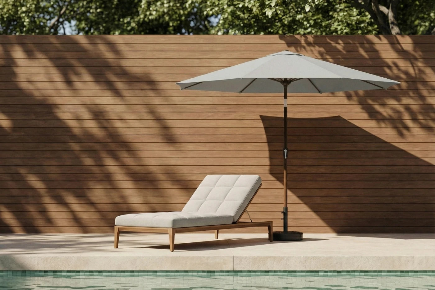 Chaise lounge with umbrella by a poolside against a wooden wall