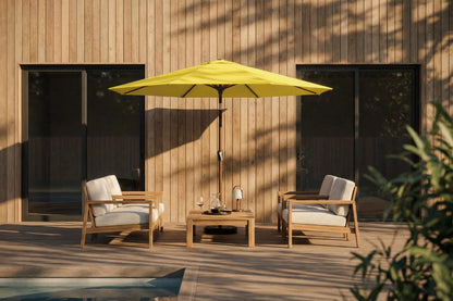 Outdoor patio set with two chairs and a table under a yellow umbrella on a wooden deck.