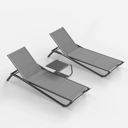 Two gray lounge chairs with a small table on a white background