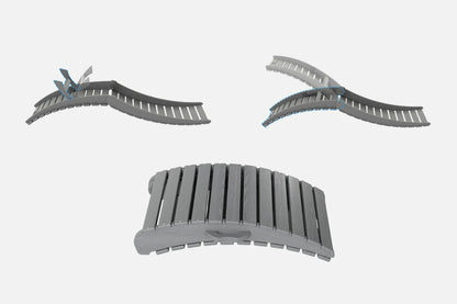 Three gray plastic track pieces on a white background