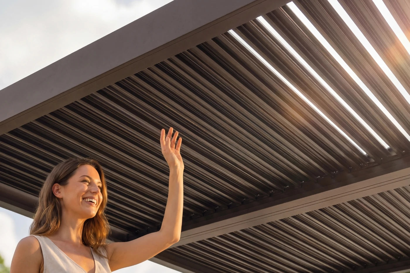 Woman waving under a retractable roof