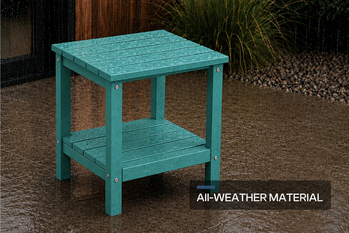 A teal outdoor side table with a slatted top and lower shelf, shown on a wet gravel patio with grass in the background. A text overlay in the bottom right reads 'All-WEATHER MATERIAL'.