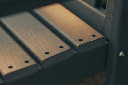Close-up of wooden slats with metal brackets on a dark background