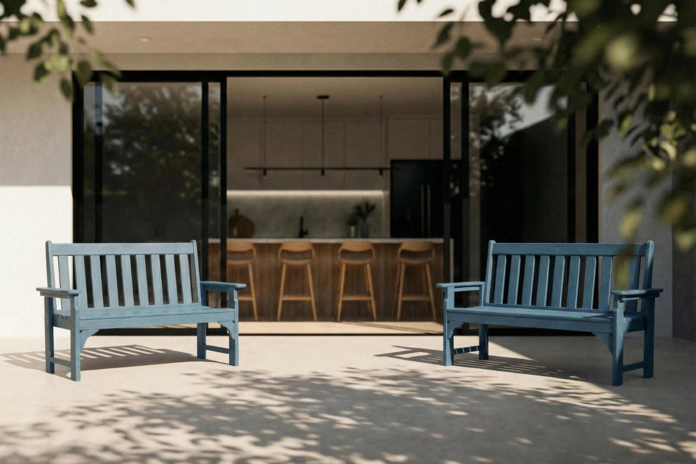 Two blue benches on a patio with a modern house interior visible through large windows.