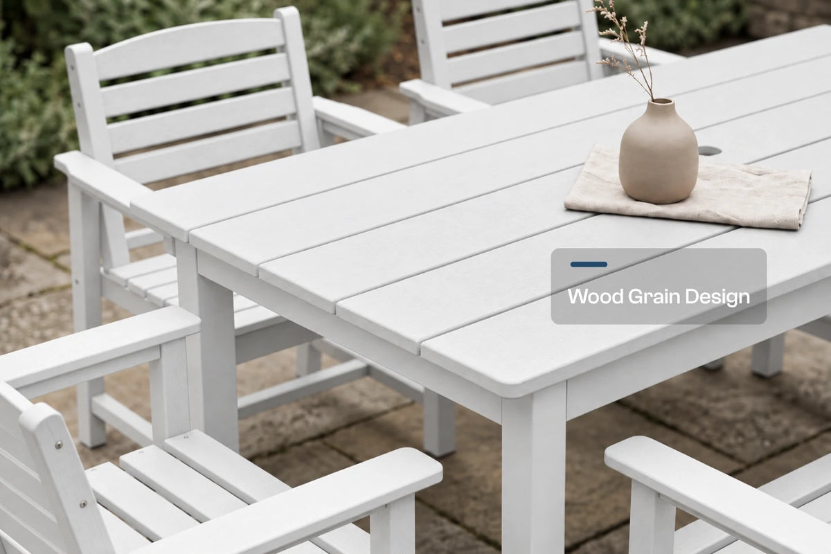 White outdoor dining table and matching chairs on a stone patio, with a small beige vase on the table and a label reading 'Wood Grain Design' overlaid near the bottom right.