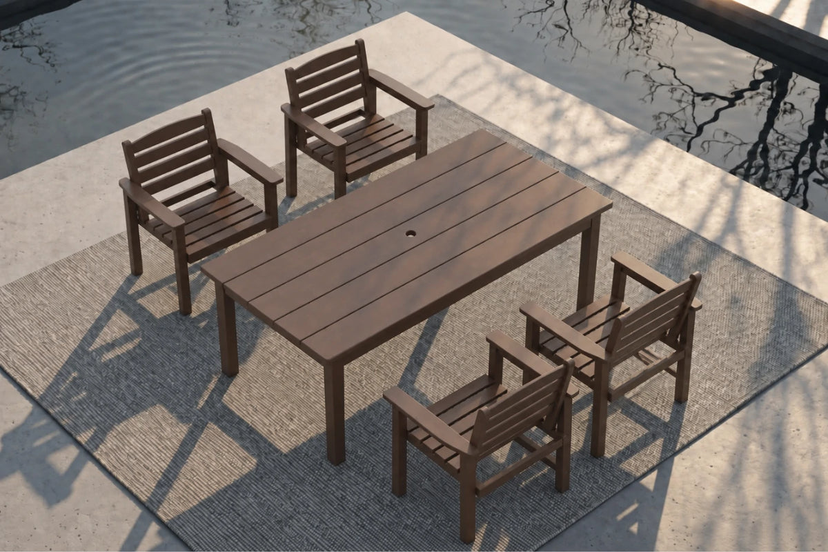 A 5-piece outdoor dining set consisting of a rectangular slatted table and four matching armchairs, shown from an elevated angle on a patio next to a body of water.