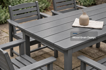 Gray outdoor dining table and matching slatted chairs on a stone patio, with a small vase on the table and a text overlay reading 'Wood Grain Design'.