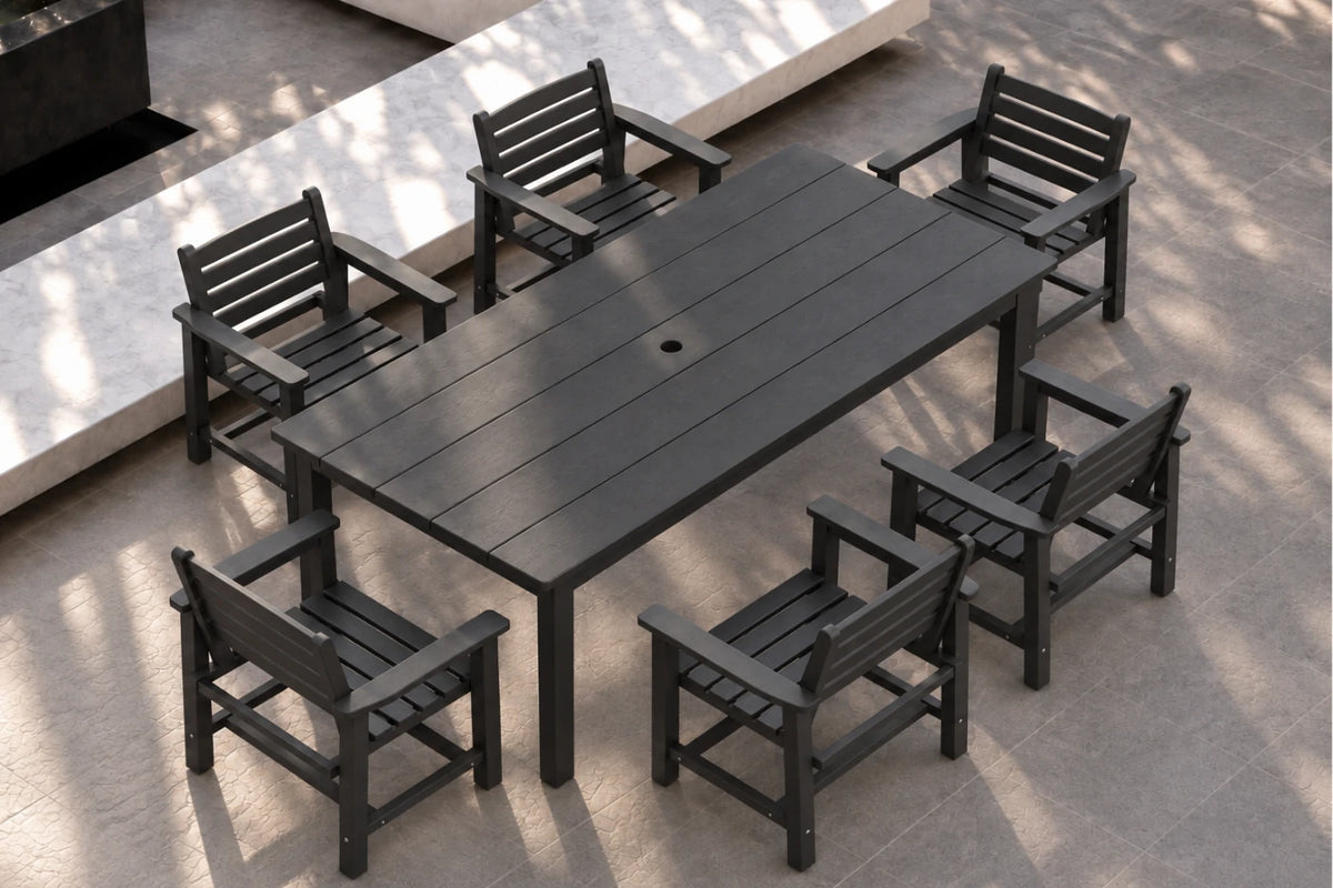 A black outdoor dining set consisting of a rectangular slatted table and six matching armchairs, shown from an elevated angle on a stone patio.