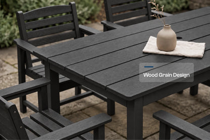 Black outdoor dining set with a slatted table and matching armchairs on a stone patio, featuring a small beige vase on a white napkin. A text overlay reads 'Wood Grain Design'.