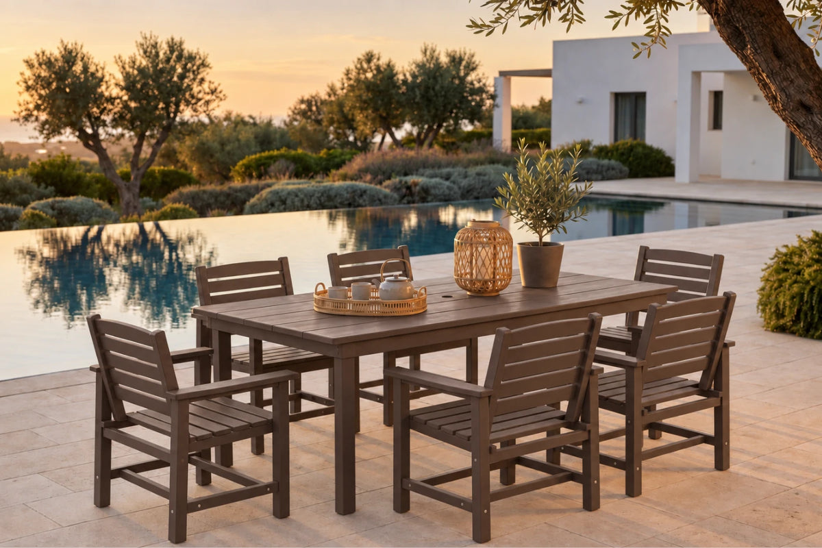 A 7-piece outdoor dining set consisting of a rectangular coffee-colored table and six matching slatted chairs, styled on a patio next to an infinity pool at sunset.